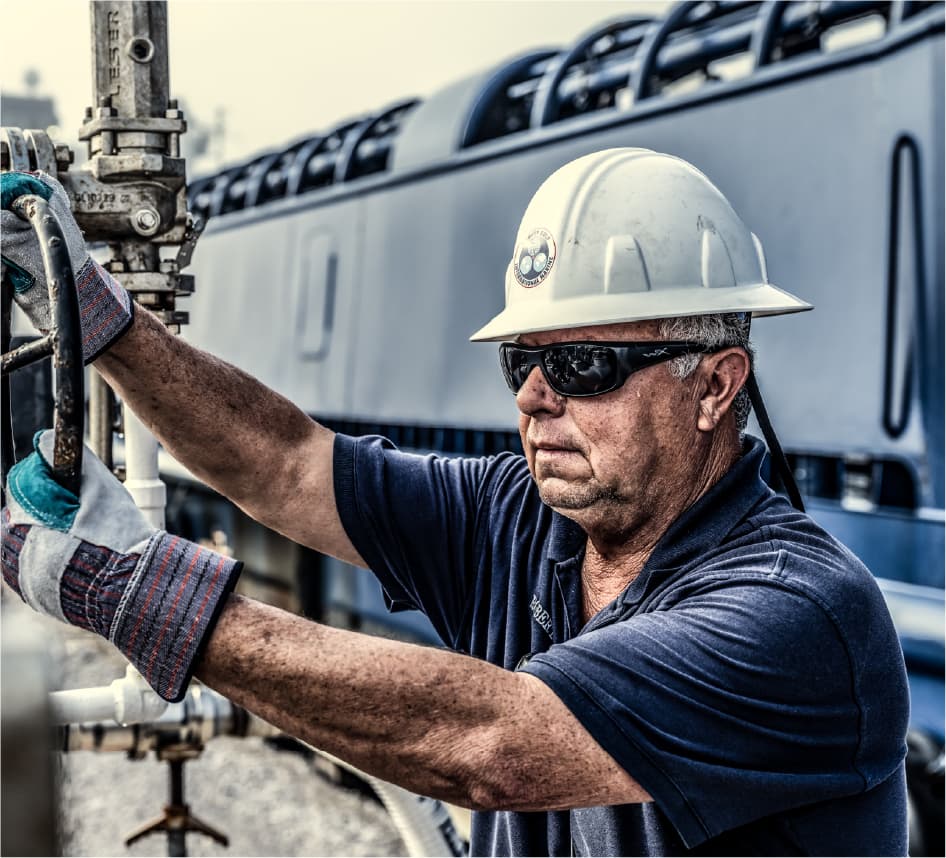 Harvey Gulf team member operating equipment with safety gear